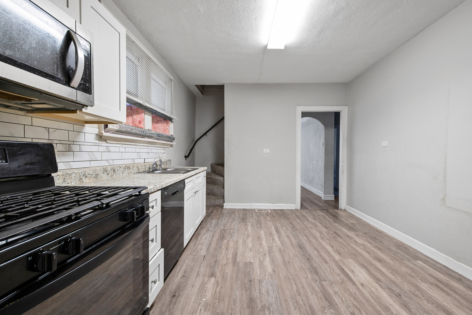 1040 West 92nd Place Chicago, IL 60620 - Photo 11 of 19 a kitchen with stainless steel appliances a stove a sink and a hard wood floor