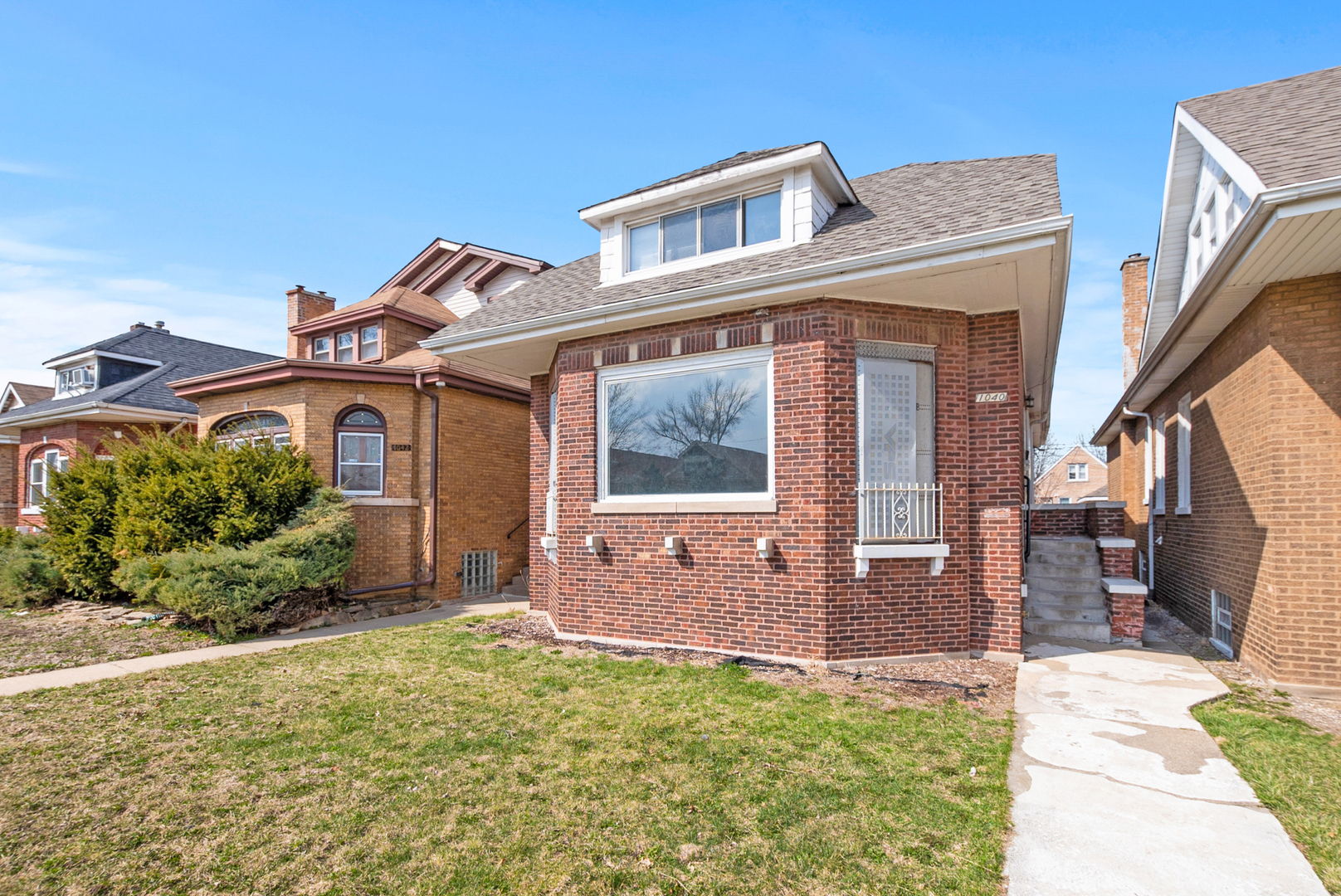 1040 West 92nd Place Chicago, IL 60620 - Photo 2 of 19 a front view of a house with garden