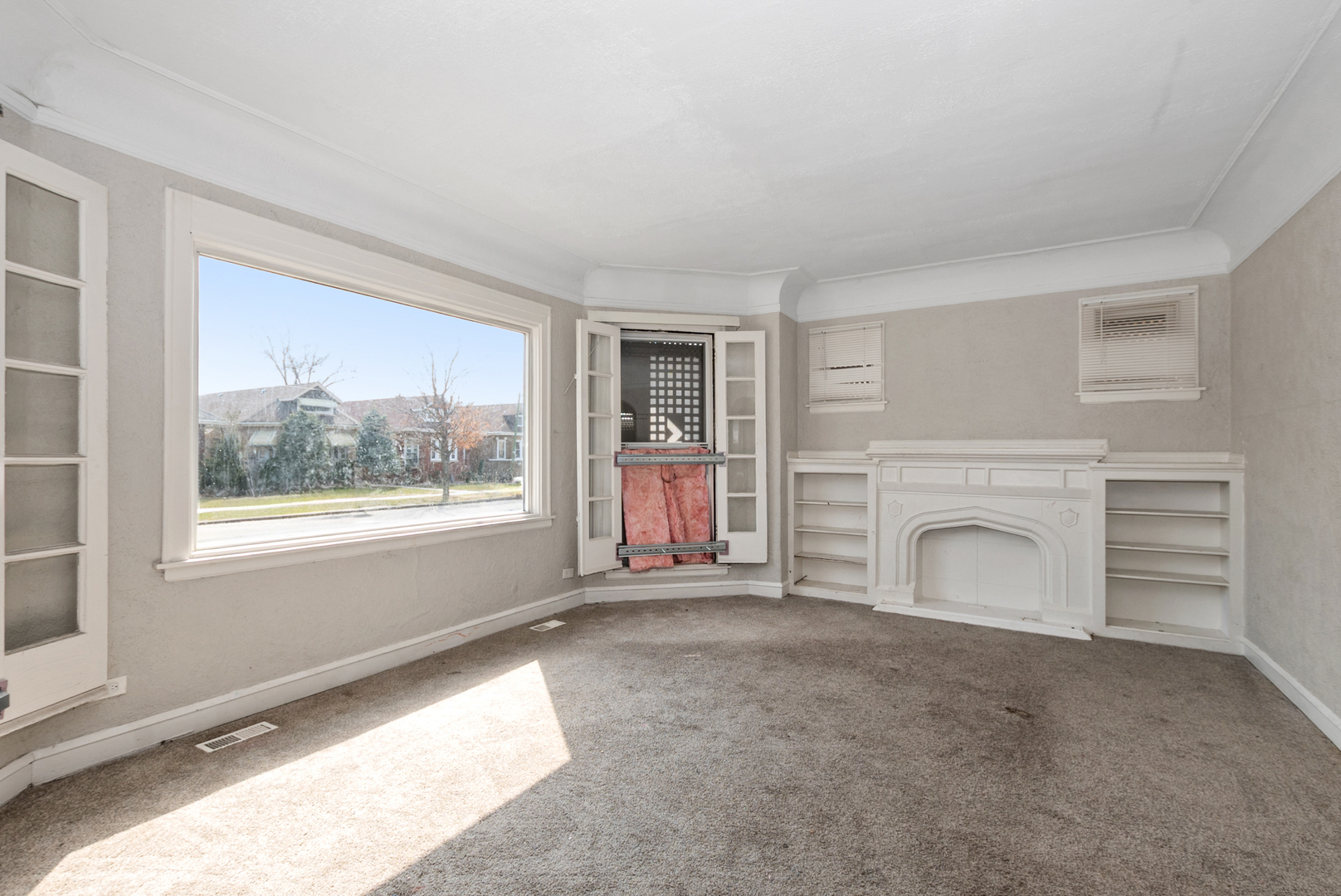1040 West 92nd Place Chicago, IL 60620 - Photo 3 of 19 a view of a livingroom with an empty space and a fireplace
