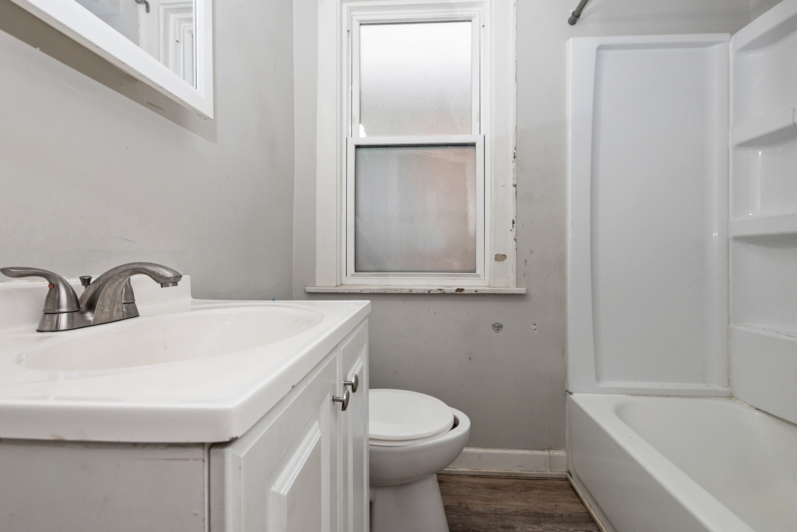 1040 West 92nd Place Chicago, IL 60620 - Photo 7 of 19 a bathroom with a sink a toilet and shower