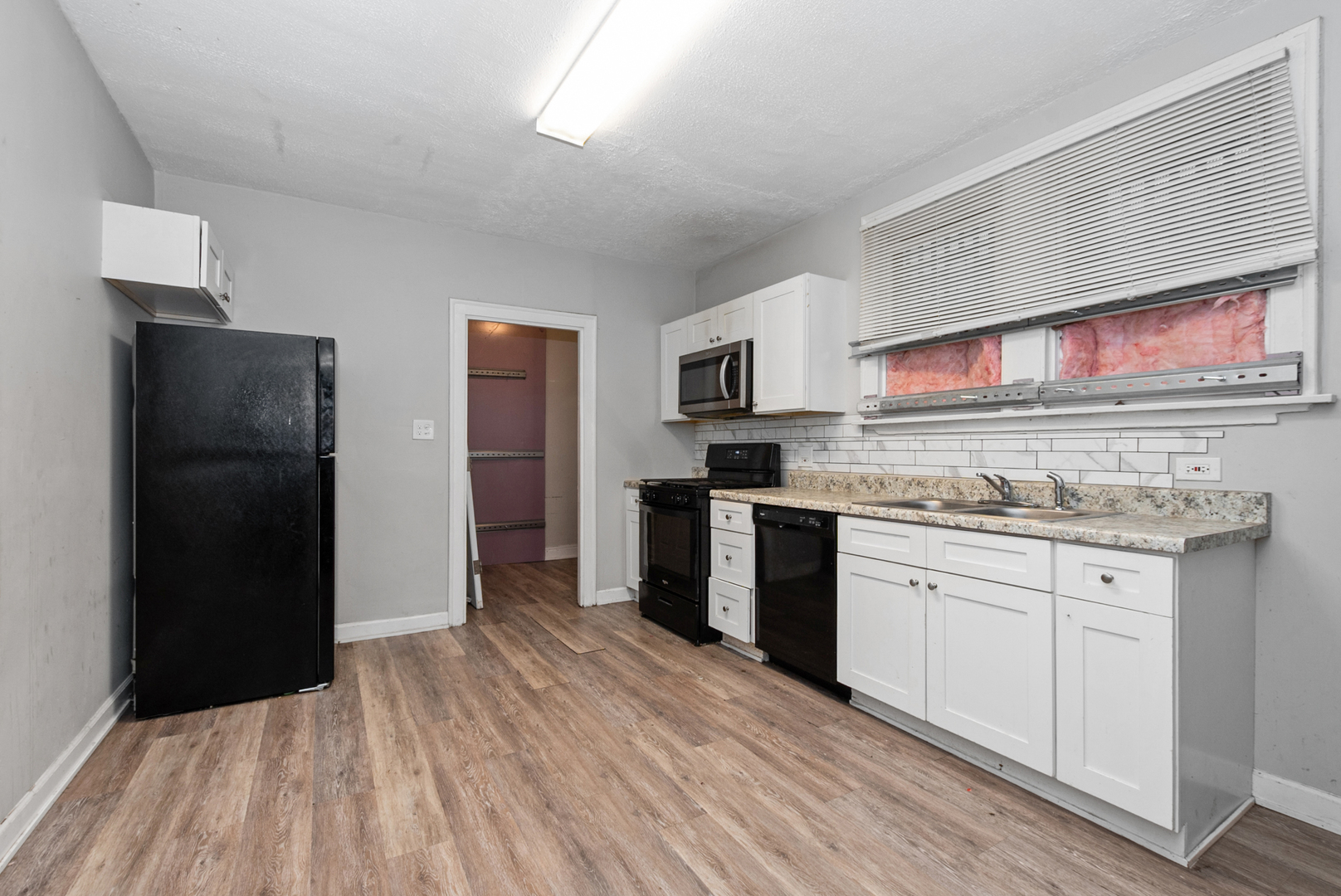 1040 West 92nd Place Chicago, IL 60620 - Photo 8 of 19 a kitchen with granite countertop a refrigerator stove and sink