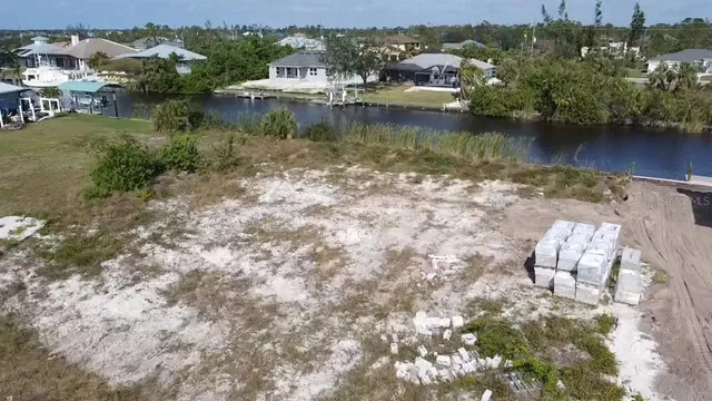 an aerial view of residential houses with outdoor space and lake view
