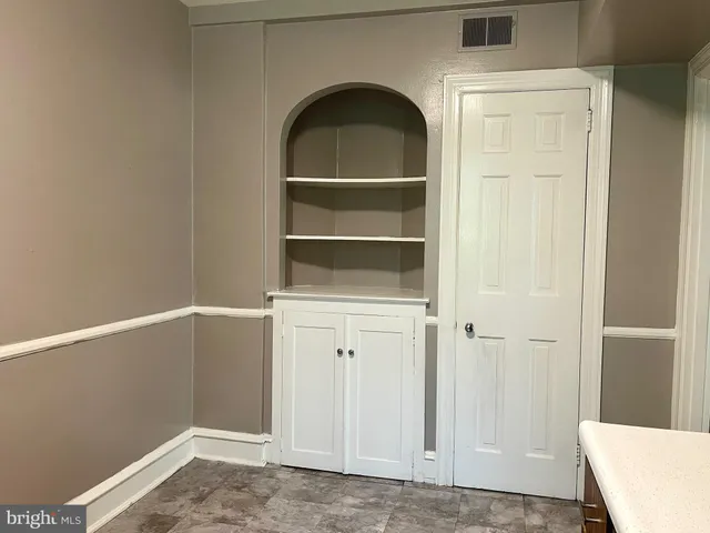 a view of storage and utility room with closet