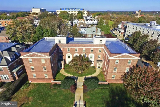 an aerial view of multiple houses with a yard