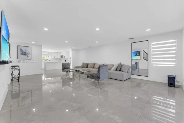 a kitchen with stainless steel appliances a refrigerator sink and microwave