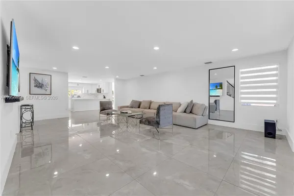 a kitchen with stainless steel appliances a refrigerator sink and microwave