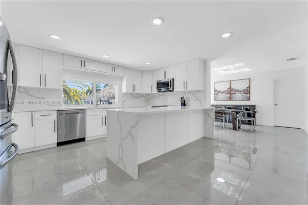 a view of a hallway with wooden floor and windows