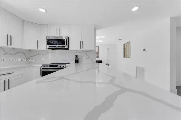a view of empty room with wooden floor and cabinet