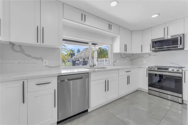 a bedroom with a large bed and a painting on the wall