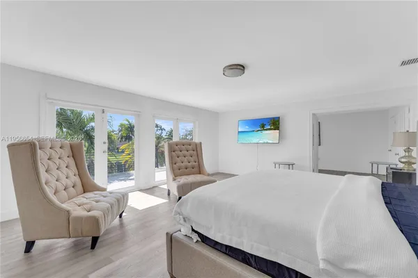 a view of a dining room with furniture and a chandelier fan