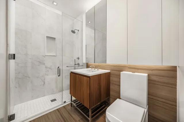 a bedroom with a bed and flat screen tv