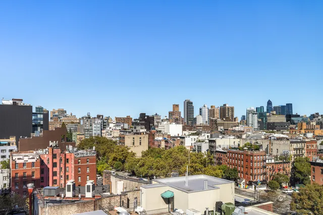 a view of a room with a hallway and wooden floor