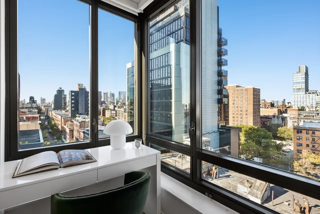 a bedroom with a large bed and a flat tv screen on dresser