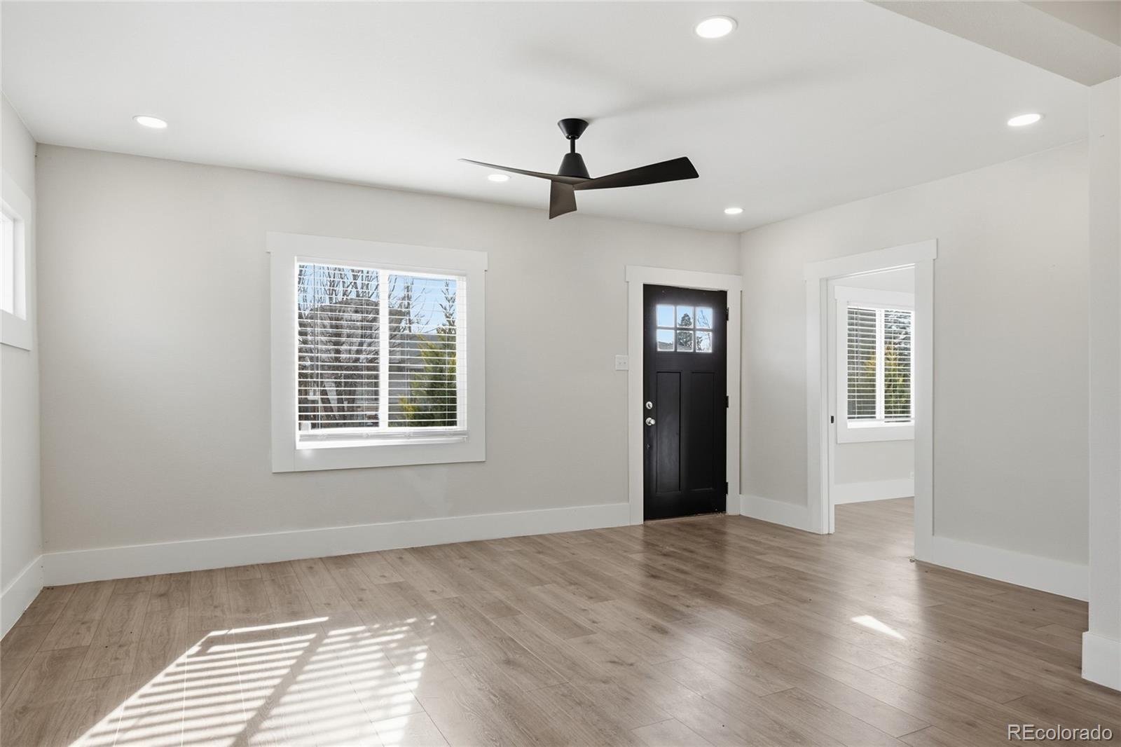 3417 West Alaska Place Denver, CO 80219 - Photo 11 of 30 a view of an empty room with wooden floor and a window