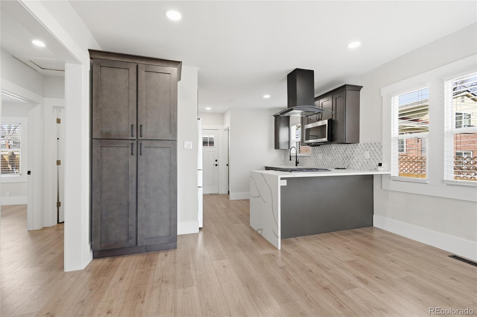 3417 West Alaska Place Denver, CO 80219 - Photo 12 of 30 a kitchen with a refrigerator and a sink