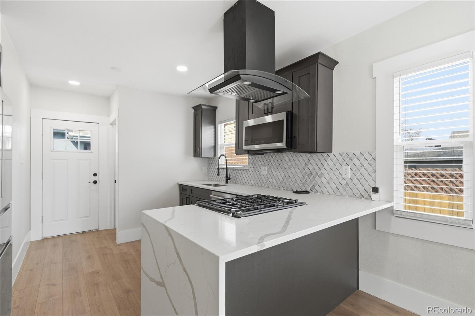3417 West Alaska Place Denver, CO 80219 - Photo 15 of 30 a kitchen with a sink cabinets and window