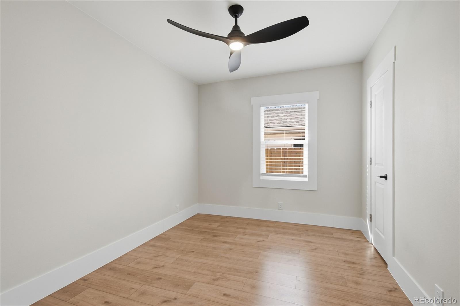 3417 West Alaska Place Denver, CO 80219 - Photo 20 of 30 a view of empty room with wooden floor and fan
