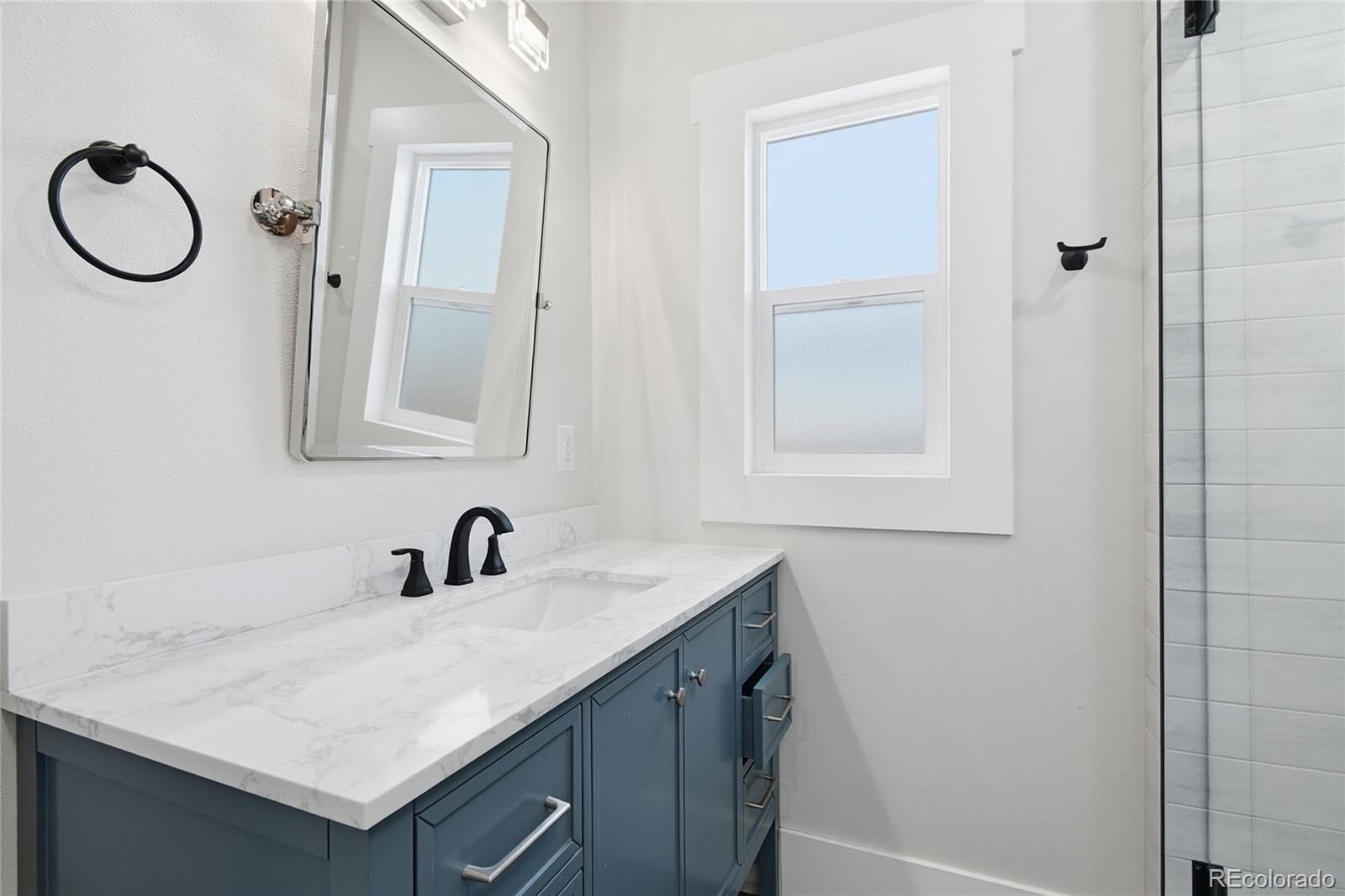 3417 West Alaska Place Denver, CO 80219 - Photo 25 of 30 a bathroom with a sink vanity and a mirror