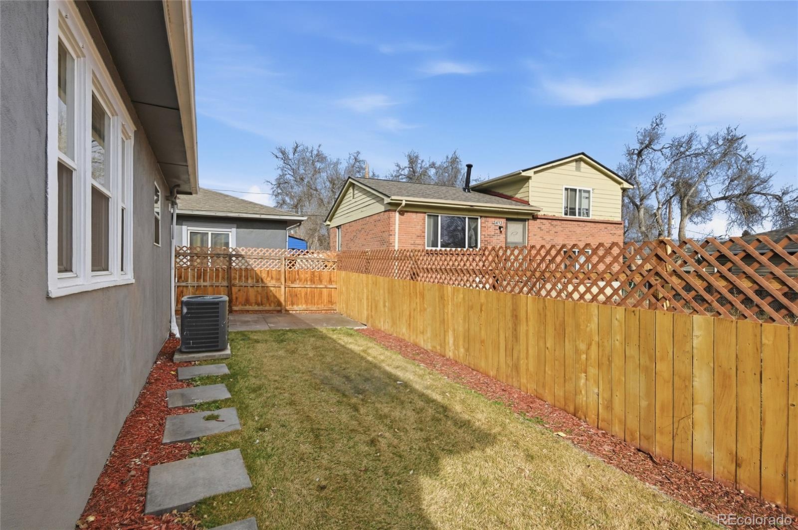 3417 West Alaska Place Denver, CO 80219 - Photo 30 of 30 a front view of a house with a yard