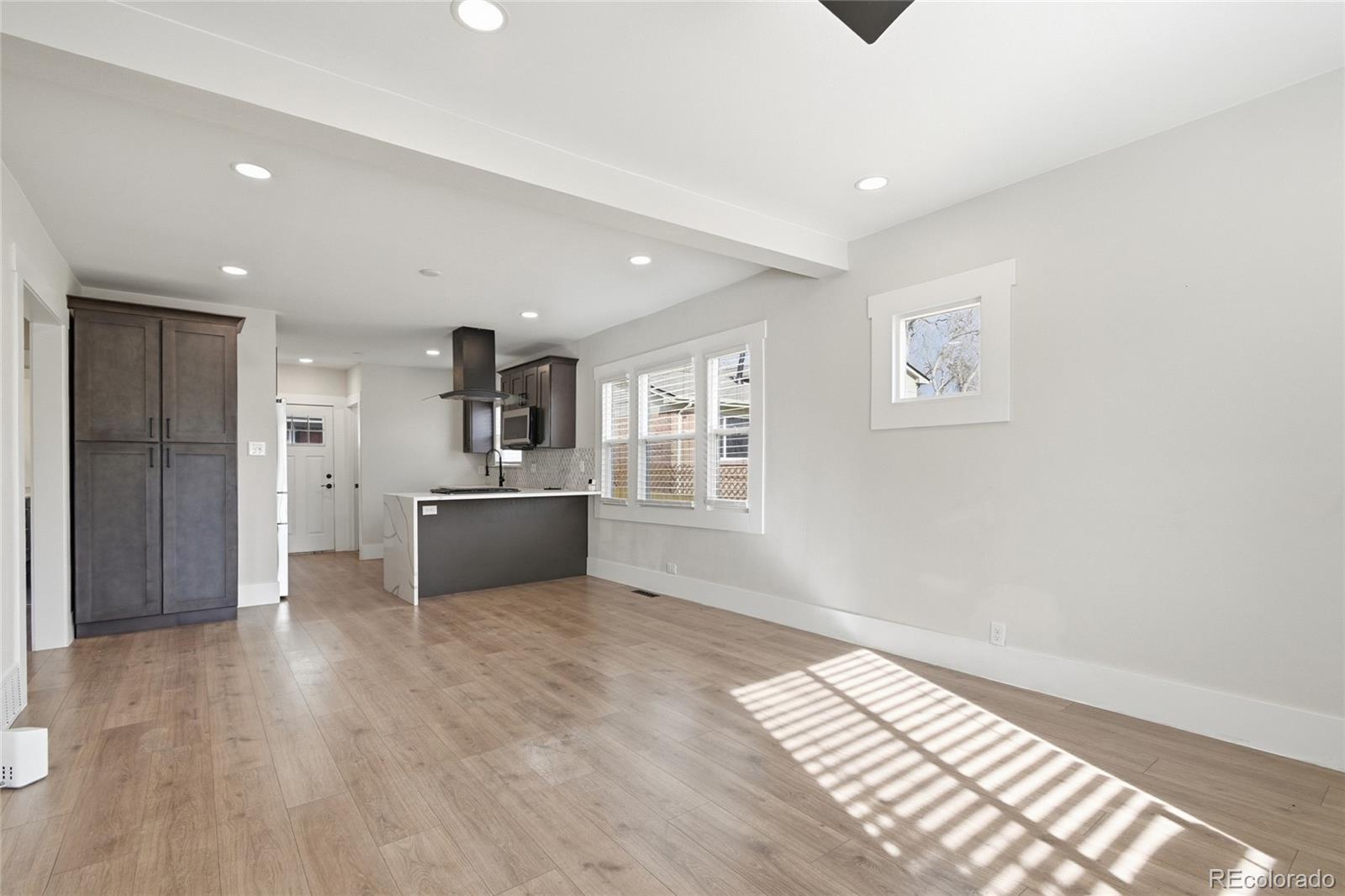 3417 West Alaska Place Denver, CO 80219 - Photo 8 of 30 a view of a kitchen with a sink and a refrigerator