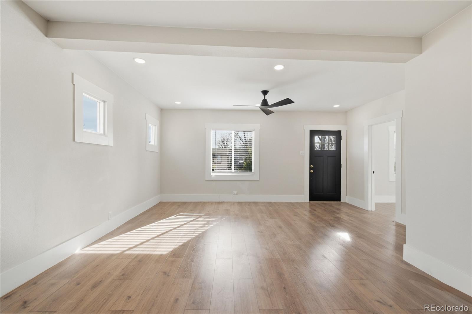 3417 West Alaska Place Denver, CO 80219 - Photo 9 of 30 a view of an empty room with wooden floor and a window
