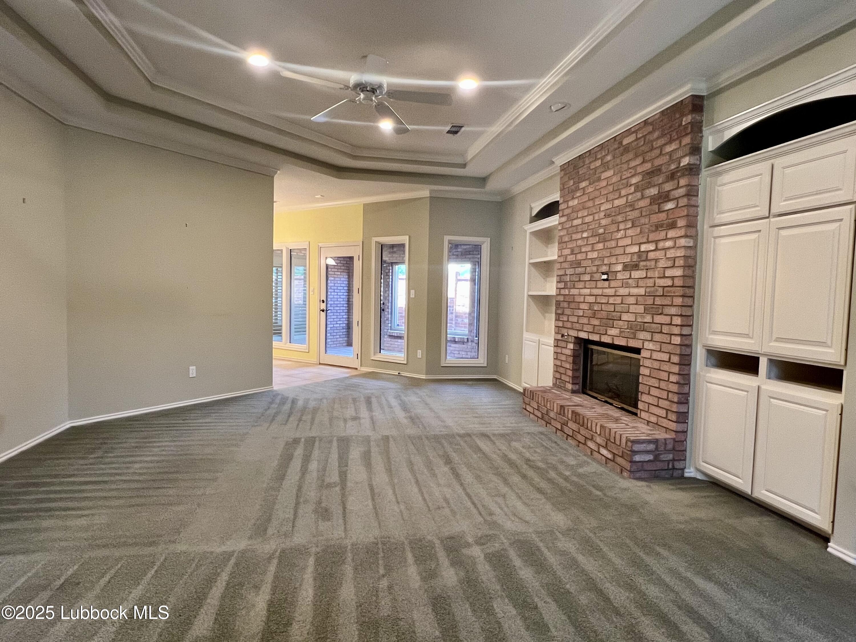 9802 Toledo Avenue Lubbock, TX 79424 - Photo 13 of 64 a view of an empty room with fire place and a window