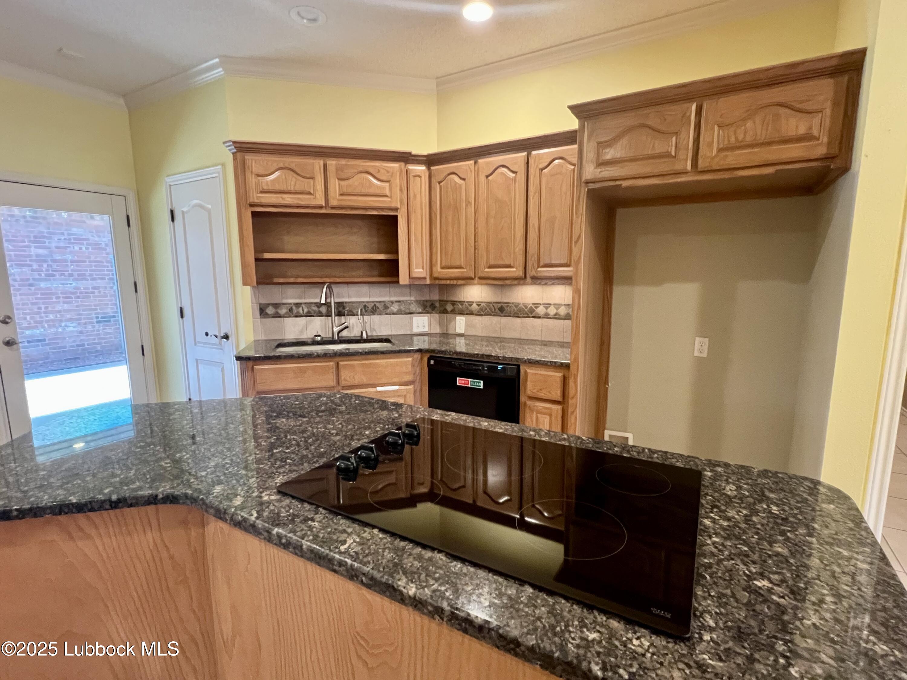 9802 Toledo Avenue Lubbock, TX 79424 - Photo 16 of 64 a kitchen with stainless steel appliances granite countertop a sink stove and granite counter top