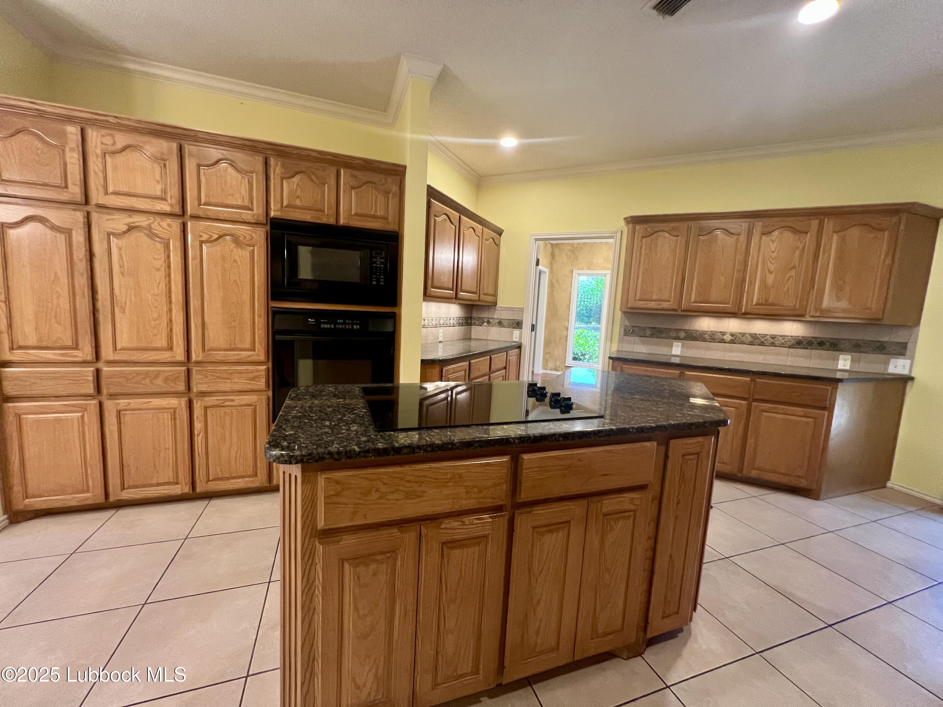 9802 Toledo Avenue Lubbock, TX 79424 - Photo 20 of 64 a kitchen with stainless steel appliances granite countertop a refrigerator and a stove top oven