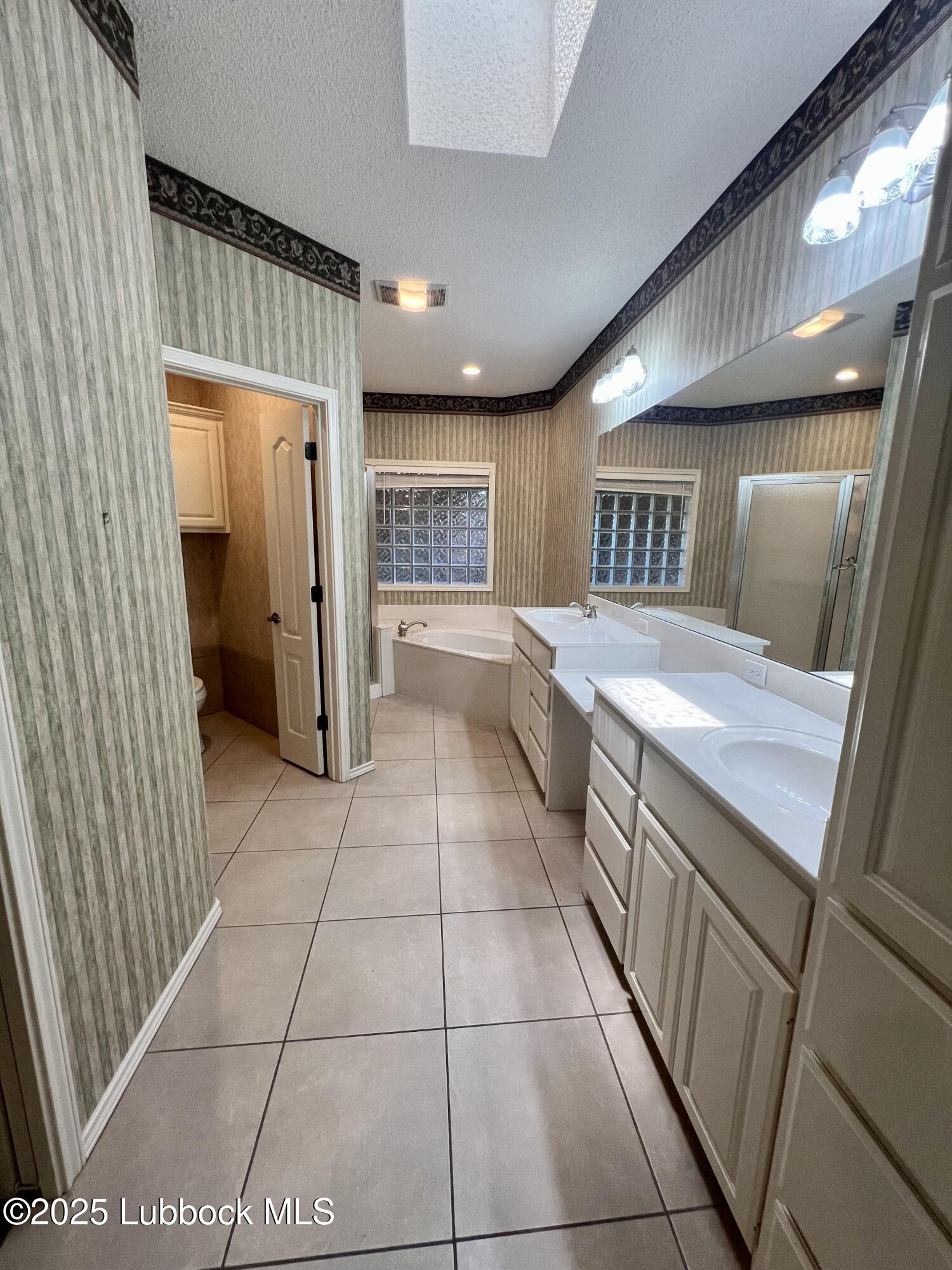 9802 Toledo Avenue Lubbock, TX 79424 - Photo 29 of 64 a large kitchen with a large counter top and stainless steel appliances