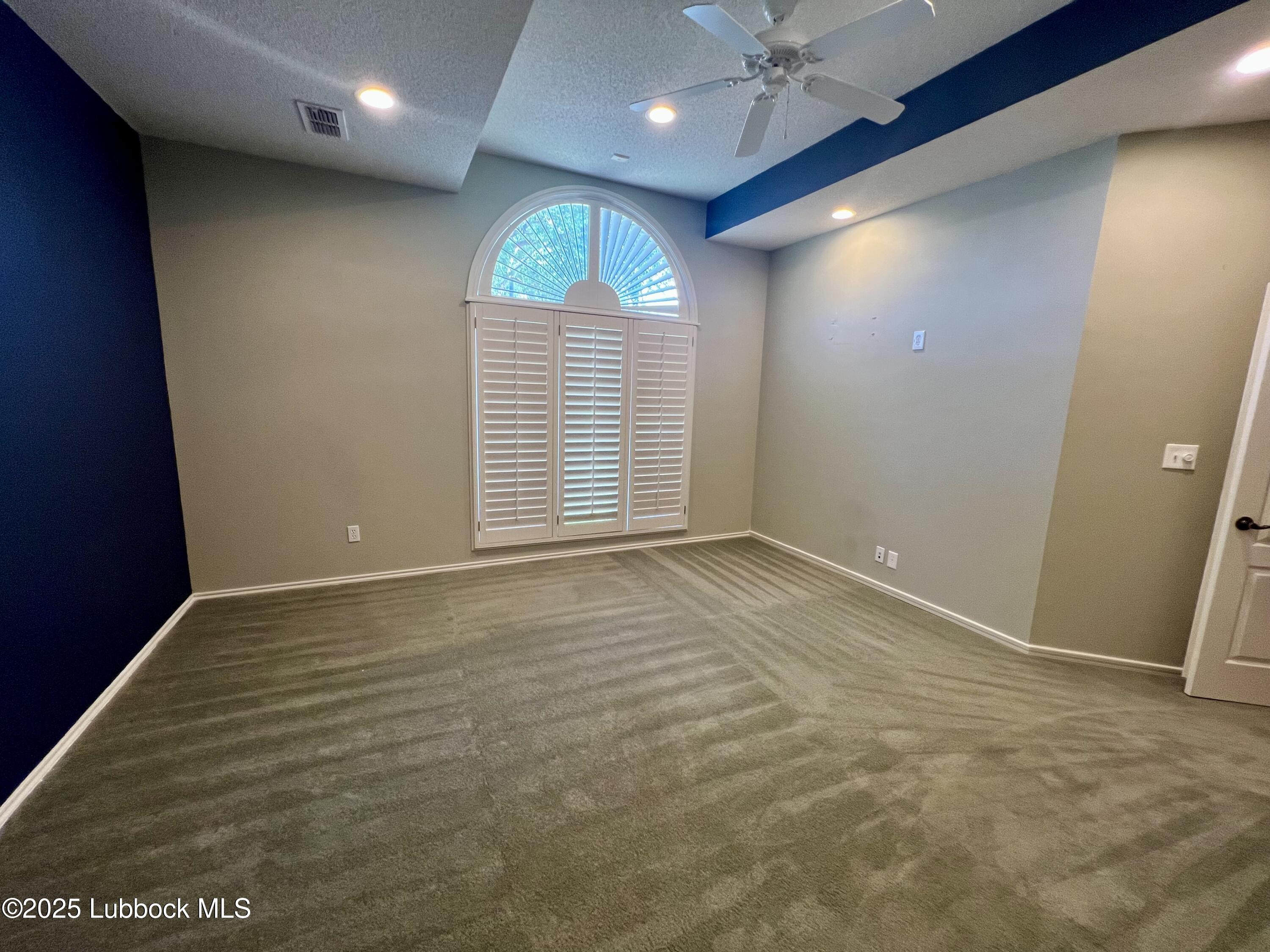 9802 Toledo Avenue Lubbock, TX 79424 - Photo 32 of 64 an empty room with wooden floor and windows