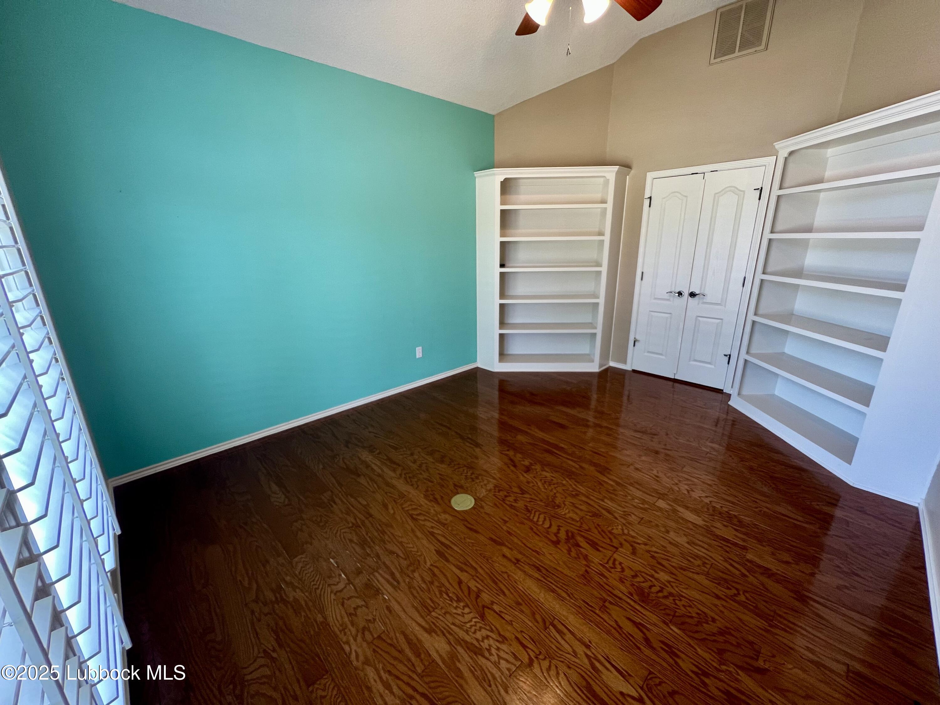 9802 Toledo Avenue Lubbock, TX 79424 - Photo 36 of 64 an empty room with wooden floor and windows