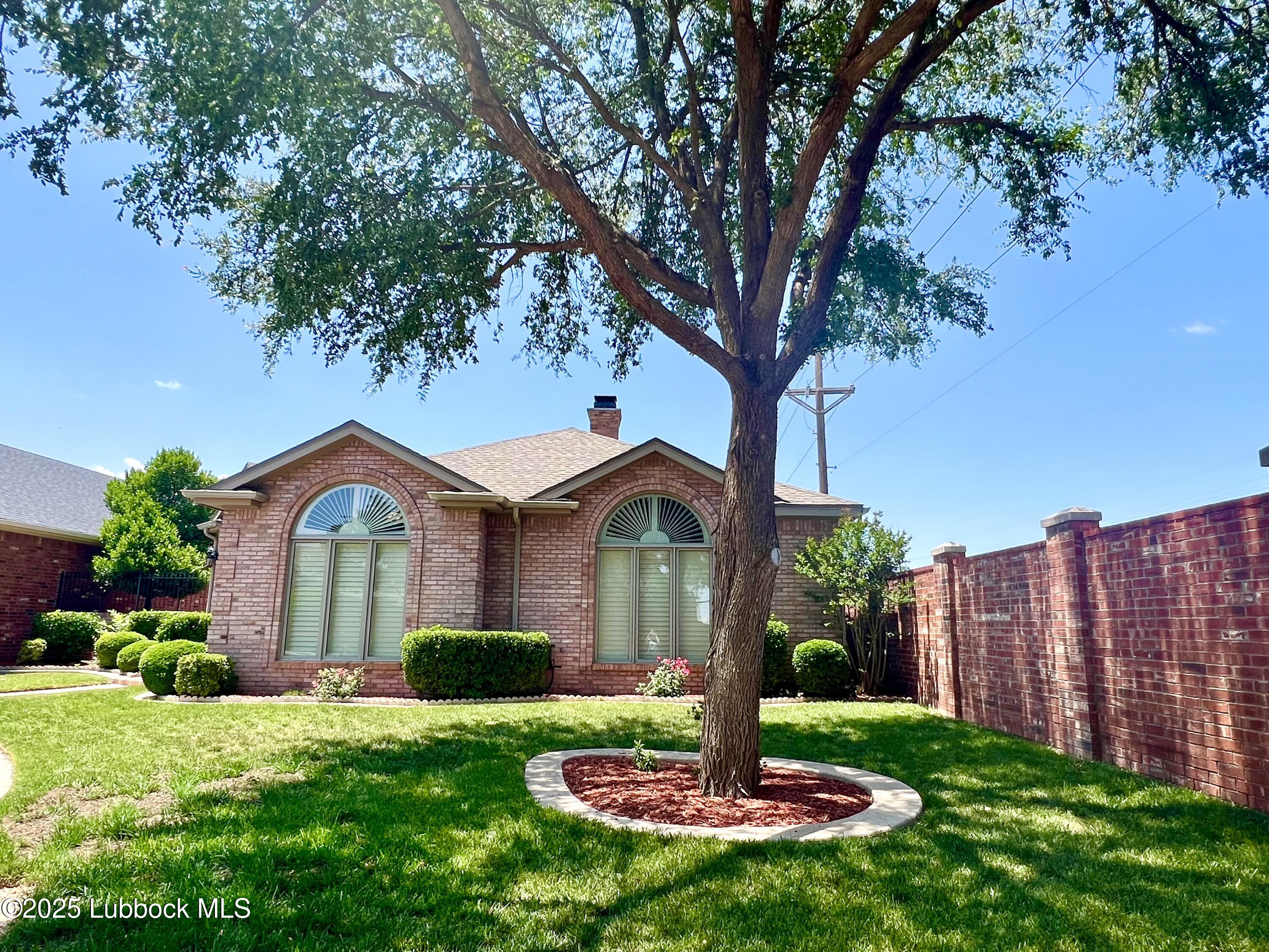 9802 Toledo Avenue Lubbock, TX 79424 - Photo 5 of 64 a front view of a house with a yard