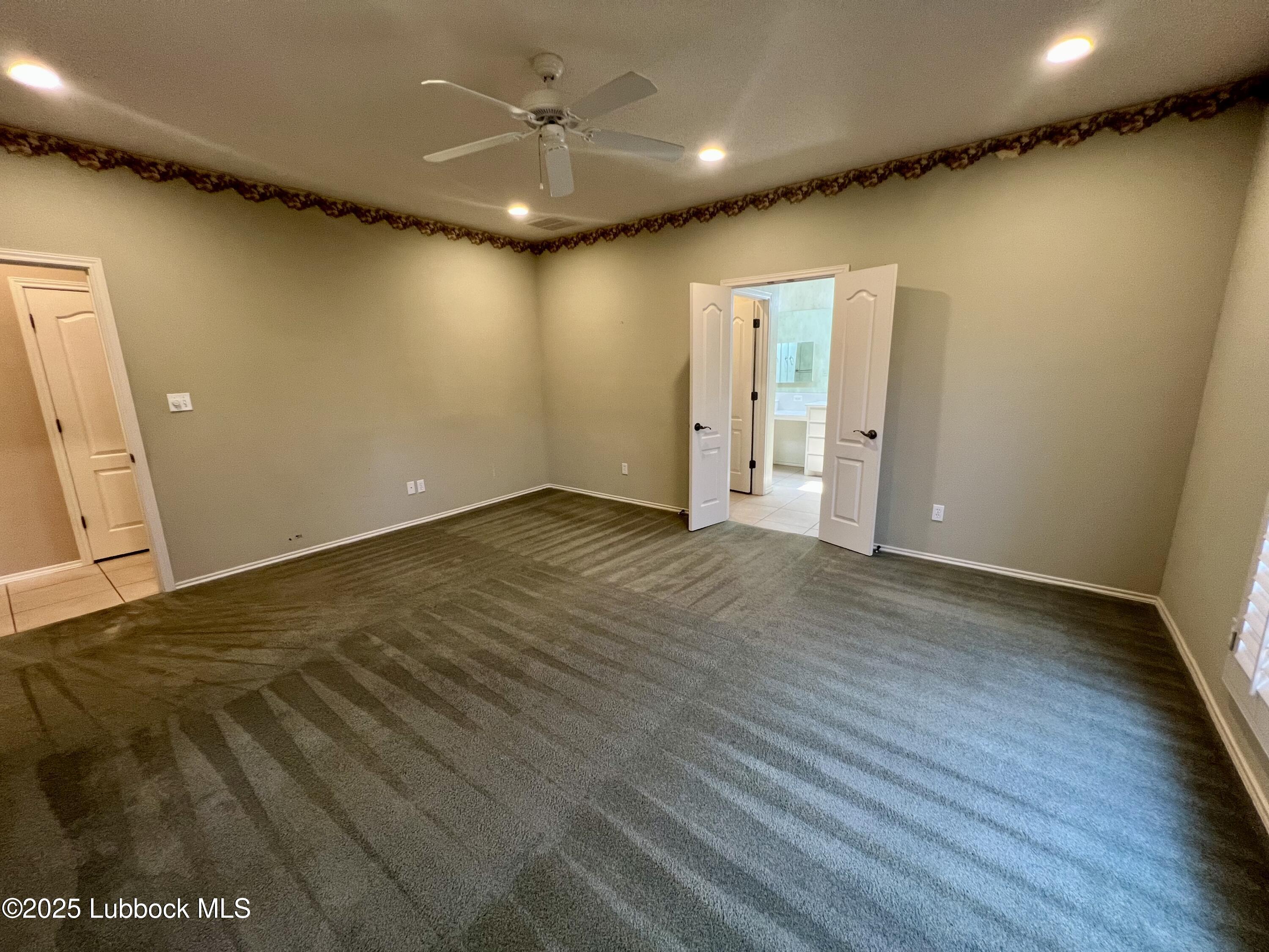 9802 Toledo Avenue Lubbock, TX 79424 - Photo 52 of 64 an empty room with wooden floor and natural light