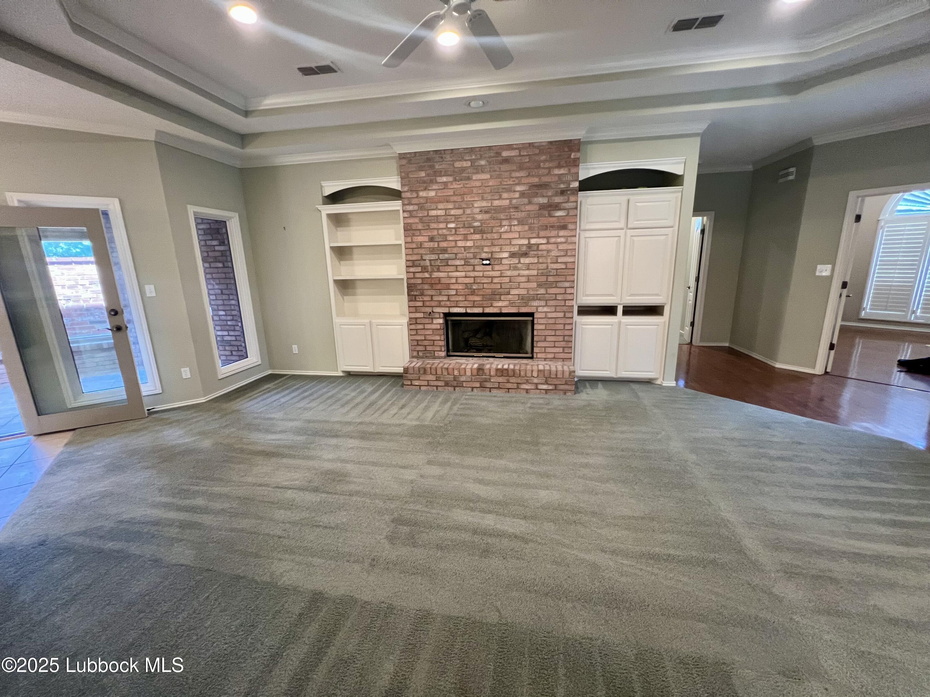 9802 Toledo Avenue Lubbock, TX 79424 - Photo 10 of 64 a view of empty room with wooden floor and fireplace