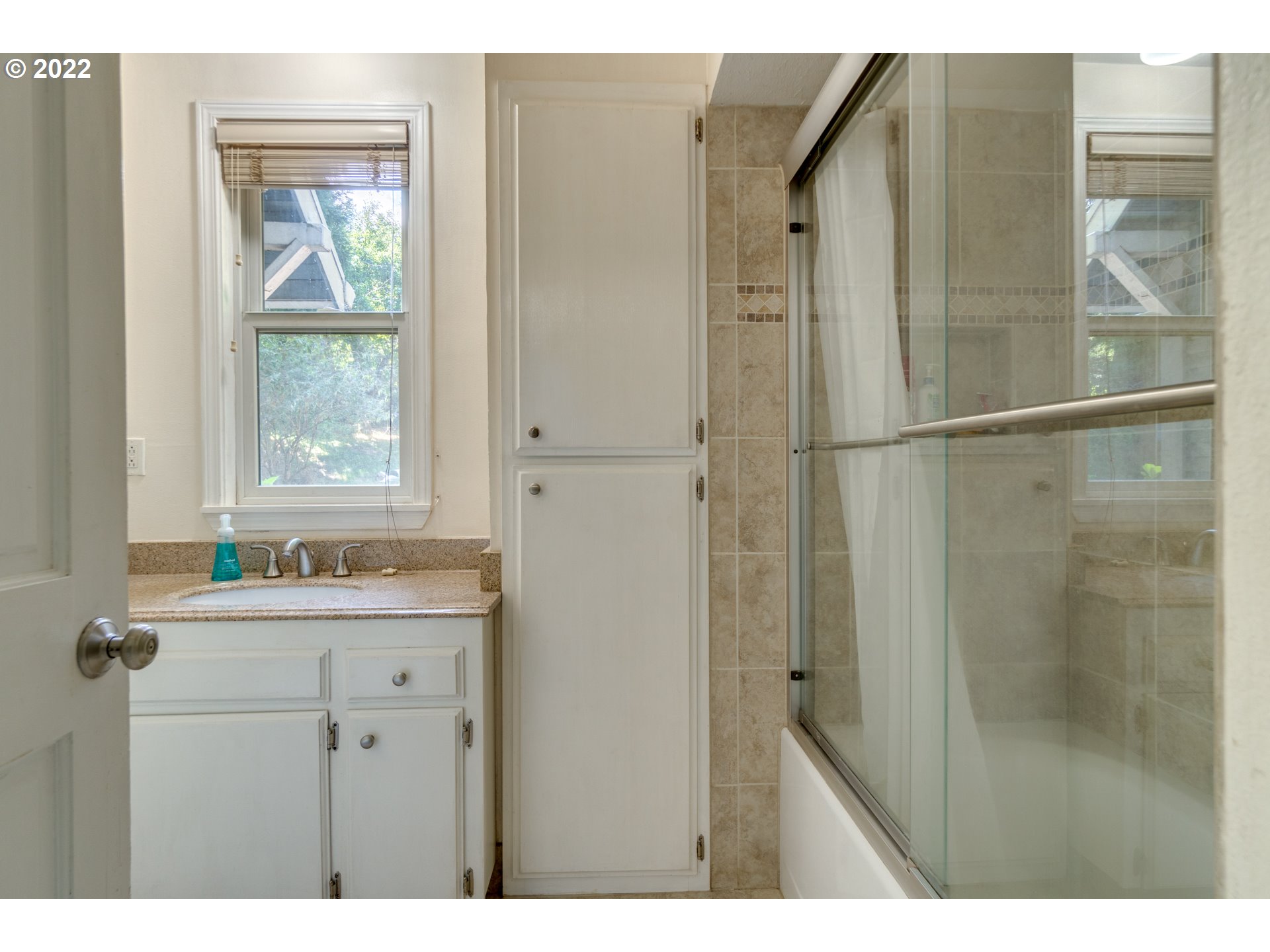 16636 Forsythe Road Oregon City, OR 97045 - Photo 12 of 29 a bathroom with a granite countertop sink a window and a shower