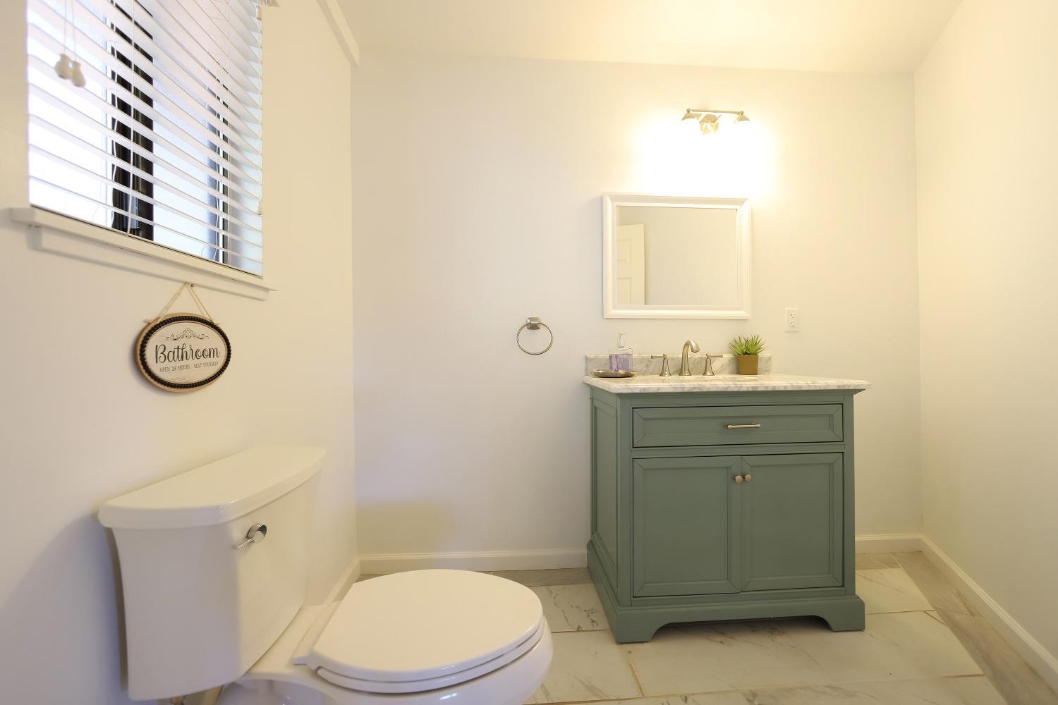 1870 Cable Road Camino, CA 95709 - Photo 14 of 36 a bathroom with a granite countertop toilet sink and mirror