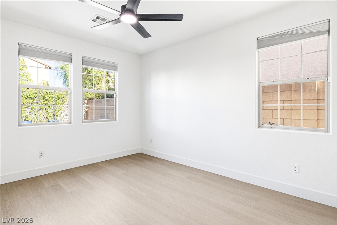 2182 Trivero Street Henderson, NV 89044 - Photo 18 of 50 Crisp white walls and clean vinyl plank flooring define this versatile secondary bedroom.
