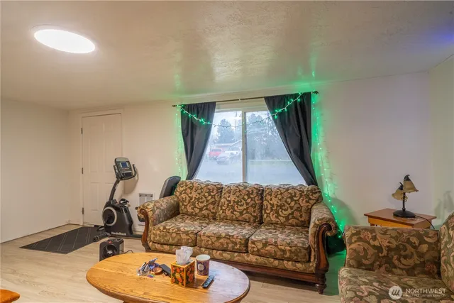 a living room with furniture a rug and a window