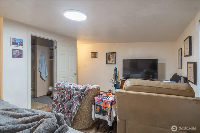 a bedroom with furniture and a flat screen tv