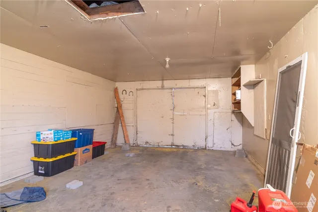 a view of storage and utility room with a window