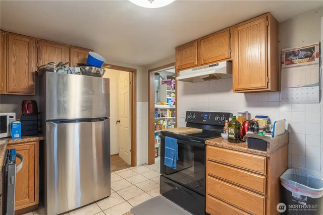 a kitchen with stainless steel appliances a refrigerator sink and cabinets