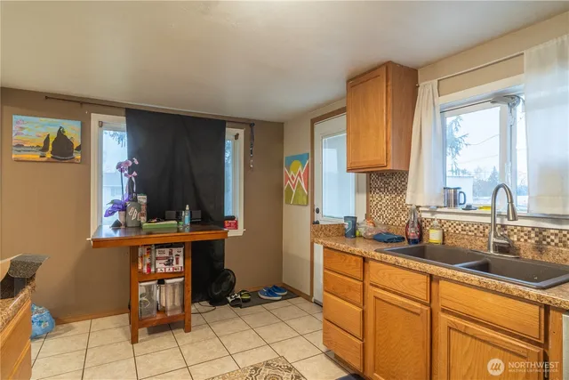 a kitchen with granite countertop a sink and cabinets