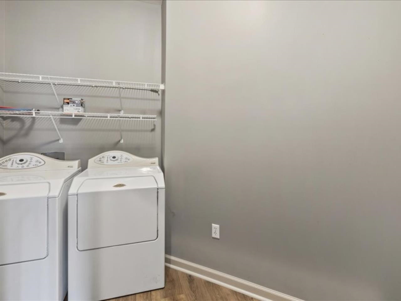 1672 Village Ridge Road, Unit 69 Collierville, TN 38017 - Photo 13 of 23 Clothes washing area with laundry area, wood finished floors, washing machine and dryer, and baseboards