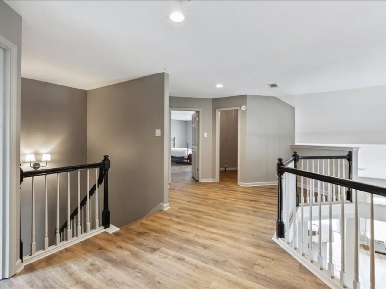 1672 Village Ridge Road, Unit 69 Collierville, TN 38017 - Photo 14 of 23 Corridor with an upstairs landing, visible vents, light wood-type flooring, and baseboards