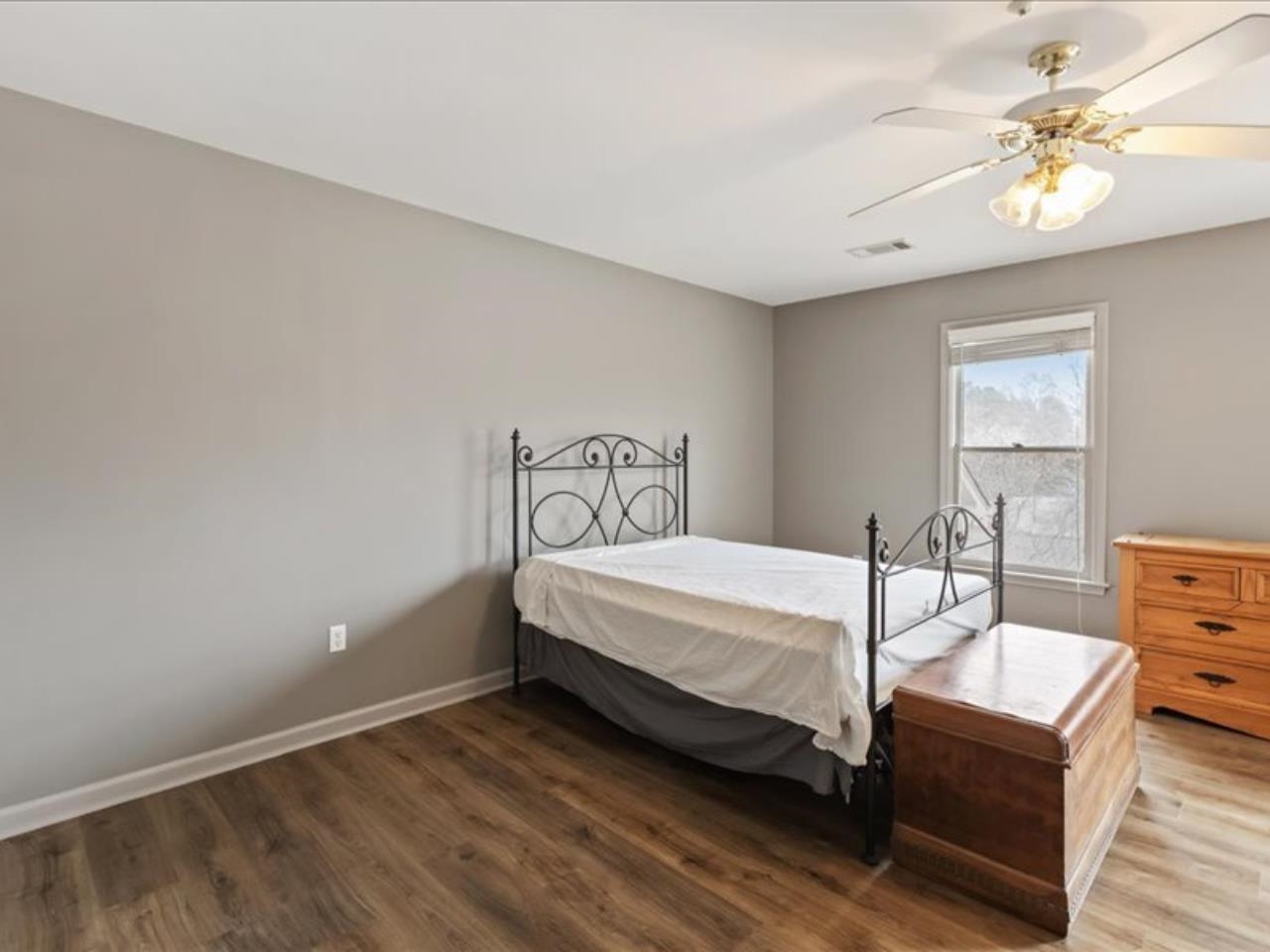 1672 Village Ridge Road, Unit 69 Collierville, TN 38017 - Photo 15 of 23 Bedroom featuring baseboards, visible vents, a ceiling fan, and wood finished floors