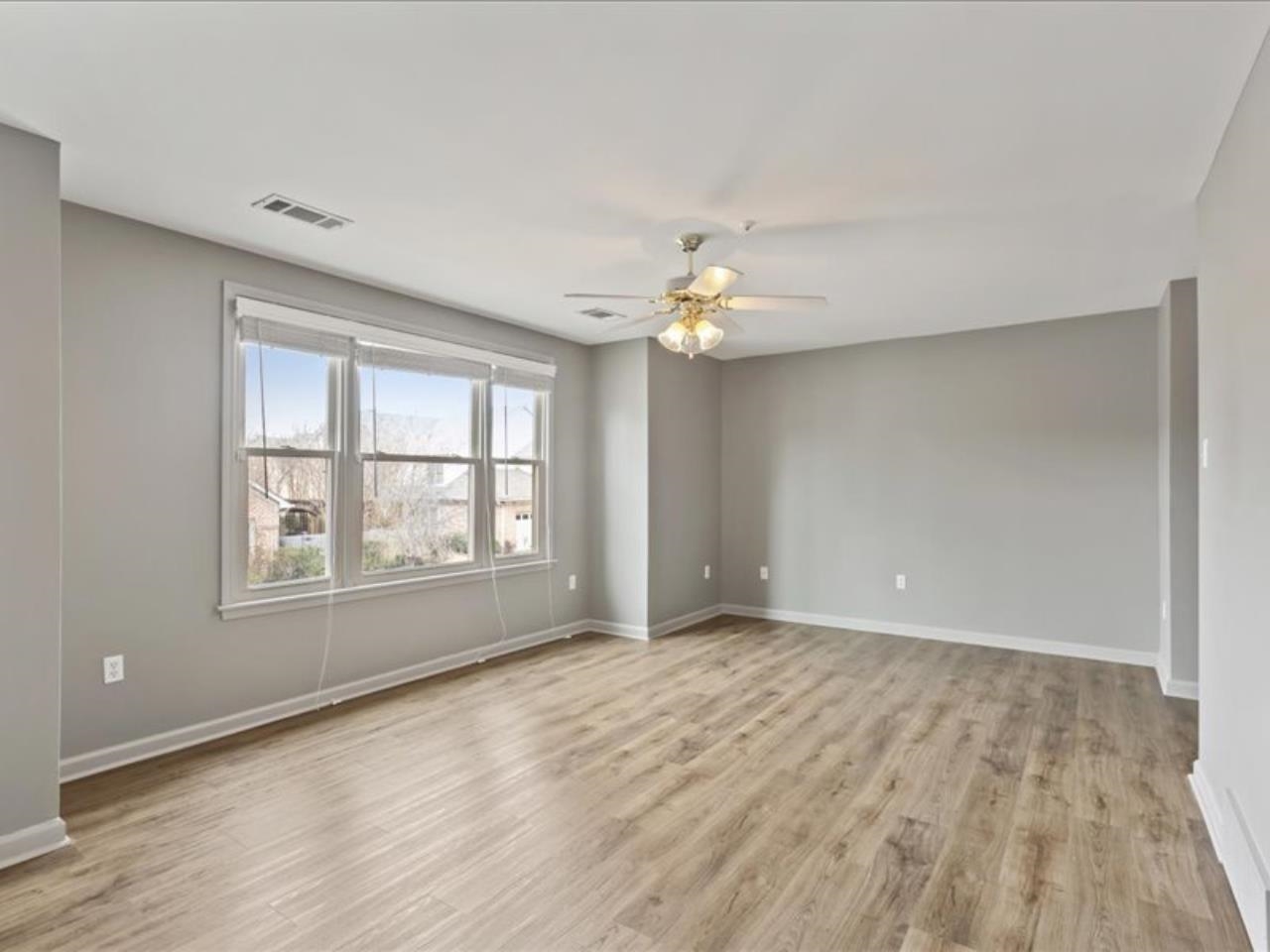 1672 Village Ridge Road, Unit 69 Collierville, TN 38017 - Photo 17 of 23 Unfurnished room featuring baseboards, visible vents, and light wood-type flooring. All bedrooms can accommodate king size furniture.