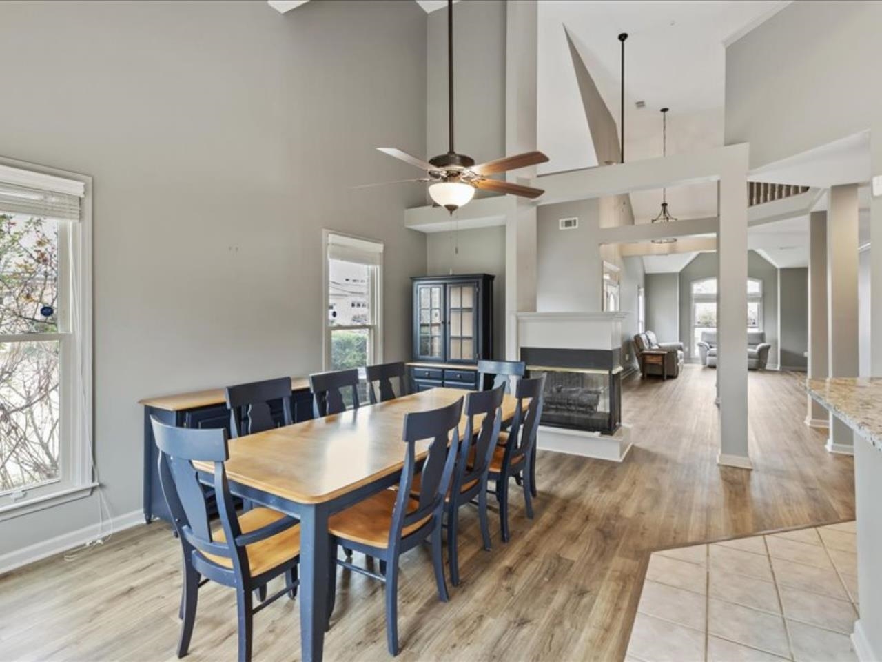 1672 Village Ridge Road, Unit 69 Collierville, TN 38017 - Photo 7 of 23 Dining space with a wealth of natural light, visible vents, a multi sided fireplace, and light wood-style flooring