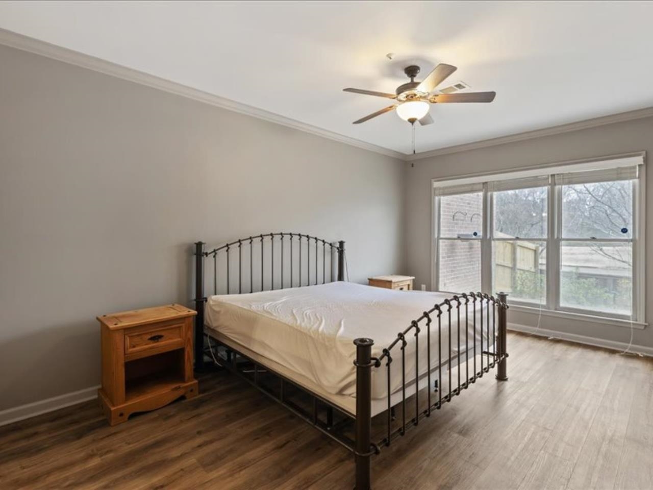 1672 Village Ridge Road, Unit 69 Collierville, TN 38017 - Photo 9 of 23 Bedroom with crown molding, a ceiling fan, wood finished floors, and baseboards