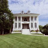 a view of a house with a yard and sitting area