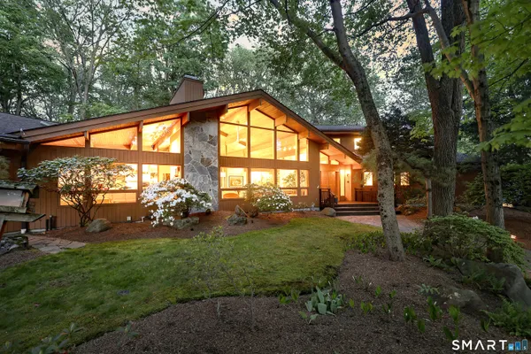 a view of yard with green space and seating